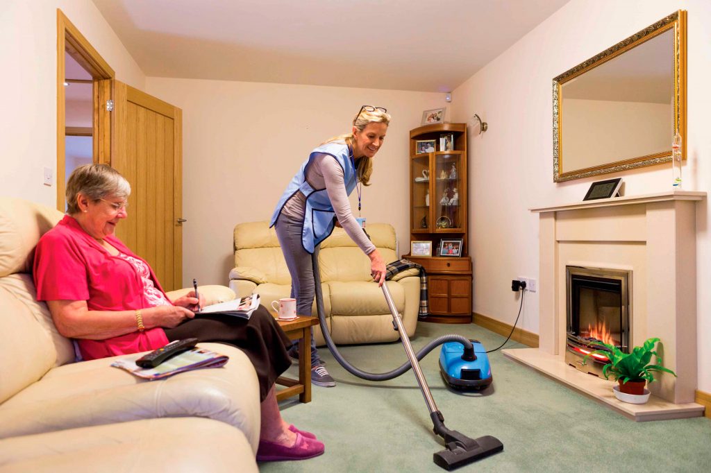 Woman vacuuming the living room